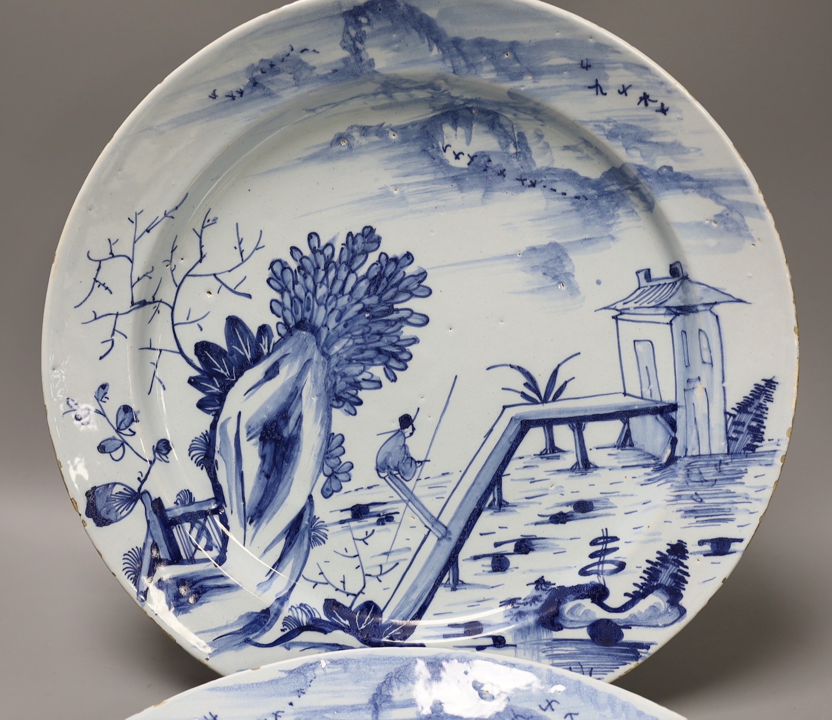 A pair of mid 18th century Delft blue and white chargers, 33.5cm diameter